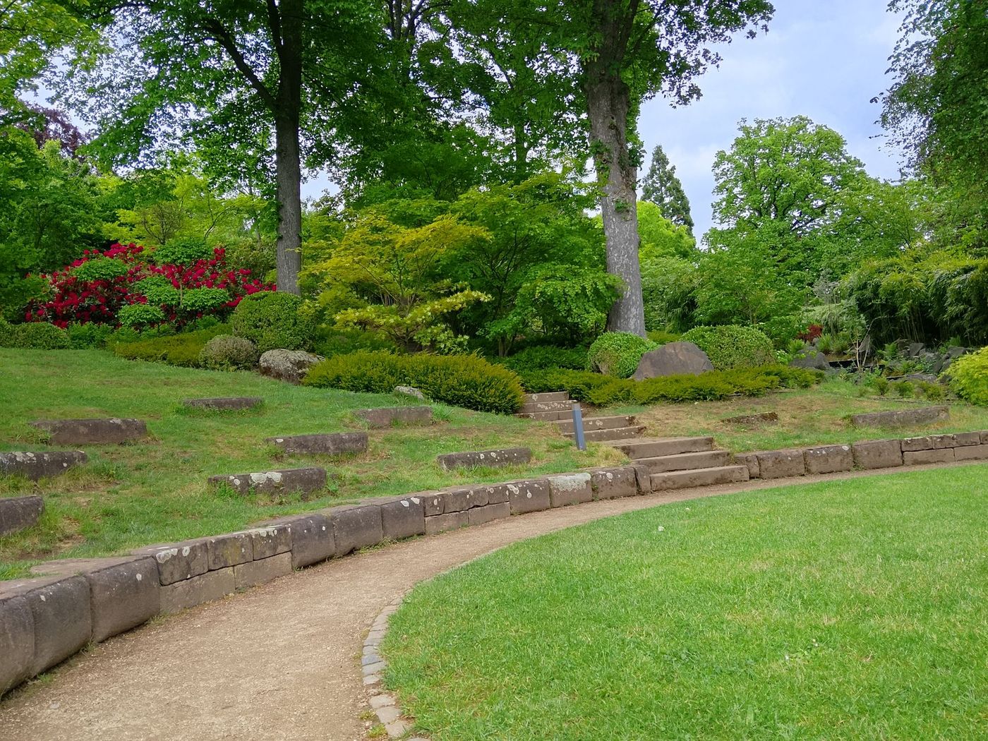 Terraced garden with stone retaining edges and lawn path